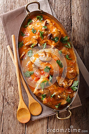 Tasty rustic French food: chicken with mushrooms stewed in sauce Stock Photo