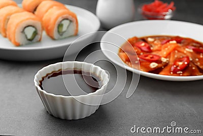 Tasty sashimi, sushi and soy sauce on grey table Stock Photo