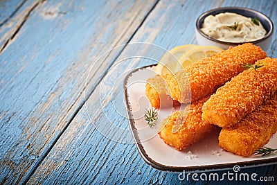 Tasty savory snack of crumbed fish sticks Stock Photo