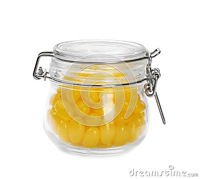 Tasty small lemon drops in glass jar isolated Stock Photo