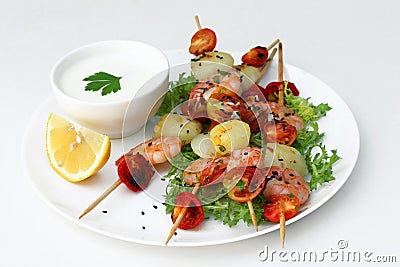 Tasty snack in fusion style: shrimp, potatoes and tomatoes in bowl Stock Photo