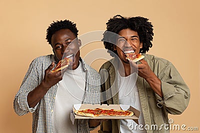 Tasty Snack. Two Hugry Black Guys Eating Italian Pizza From Box Stock Photo