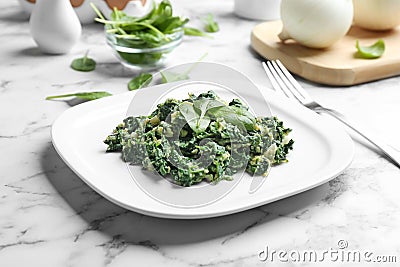 Tasty spinach on white marble table Stock Photo