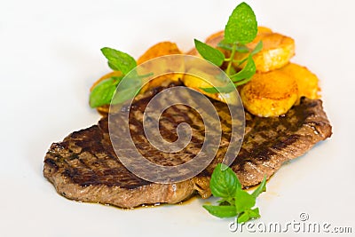 Tasty Steak with deep fried Potato Stock Photo