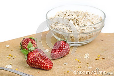 Tasty Strawberries In Front Of Bowl With Oat Meal Stock Photo