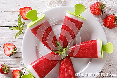 Tasty strawberry popsicle on a stick close-up. horizontal top vi Stock Photo