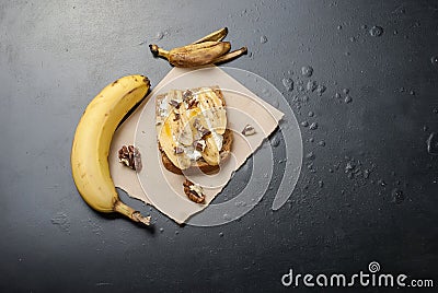 Tasty sweet sandwiches with bananas, nuts and chocolate, on bla Stock Photo