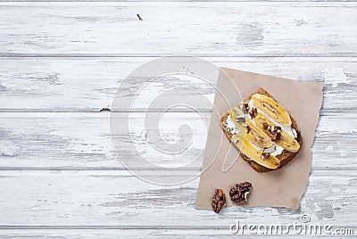 Tasty sweet sandwiches with bananas, nuts and chocolate, on woo Stock Photo