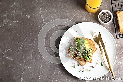 Tasty toasts with avocado, sprouts and chia seeds served Stock Photo
