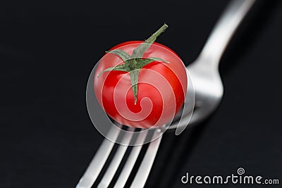 Tasty tomato on forks Stock Photo