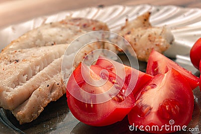 Tasty tomatoes pieces served with fish Stock Photo