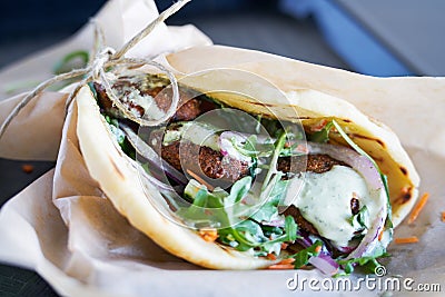 Tasty vegan falafel wrap with sauce Stock Photo