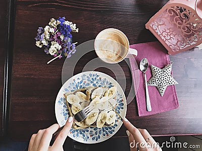 Tasty waffles with bananas and melted chocolate, hands Stock Photo