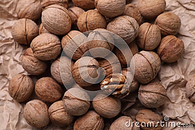 Tasty walnuts on crumpled paper Stock Photo