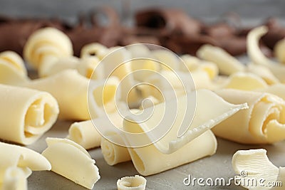 Tasty white chocolate curls on table Stock Photo