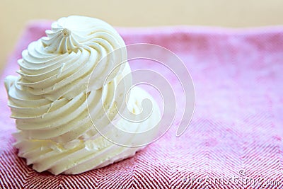 Tasty white meringue on a napkin. Stock Photo