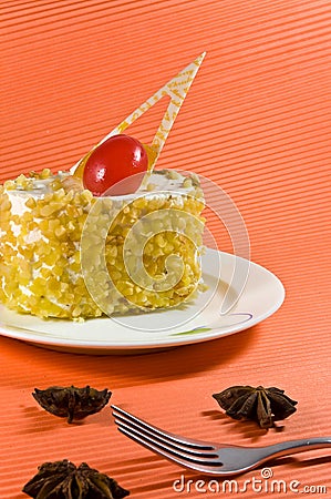 Tasty yellow nut cake with white cream. Stock Photo