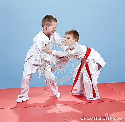 On the tatami small athletes train techniques of judo Stock Photo