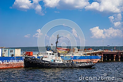 The tug is moored around the barge. Editorial Stock Photo
