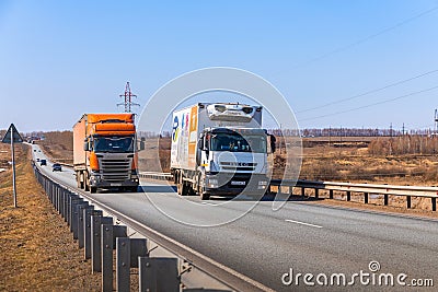 Tatarstan, Russia, Interstate Highway M7 - Apr 14th 2021. The IVECO truck overtakes the SCANIA truck. Trucks move along the Editorial Stock Photo