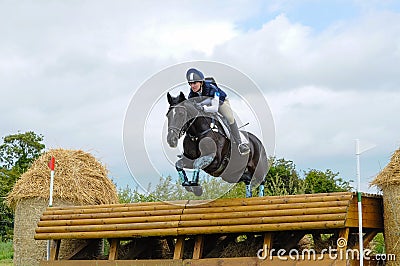 Tattersalls horse show in Ireland, black horse jumping over obstacle with male rider, jockey Editorial Stock Photo