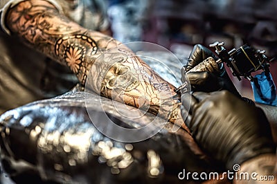 Tattoo artist drawing on arm and on skin of client Editorial Stock Photo