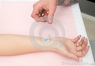 Tattoo artist at work close up Stock Photo