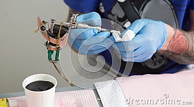 Tattoo artist at work close up Stock Photo