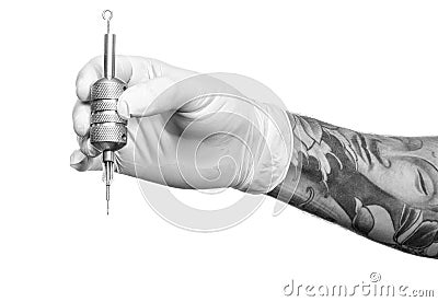 Tattoo artist at work. Preparing the needle and Editorial Stock Photo