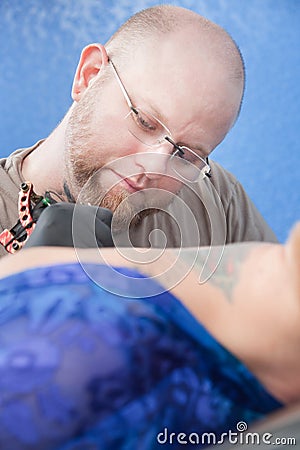 Tattoo Artist Working Stock Photo