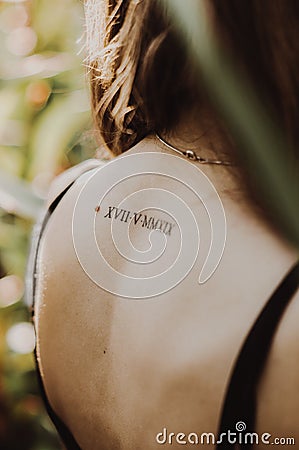 A tattoo on the back of a girl Stock Photo