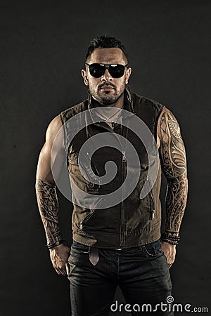 Tattoo model with beard on unshaven face. Bearded man with tattoo on strong arms. Tattooed man with biceps and triceps Stock Photo