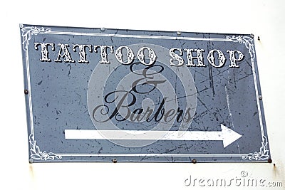 Tattoo Shop & Barbers sign on a white wall Stock Photo