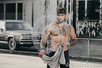 Tattooed gangster on crime street. Crime Hispanic gang members. Gangsta Crimes style. Hispanic burglar. Ethnic angry Stock Photo