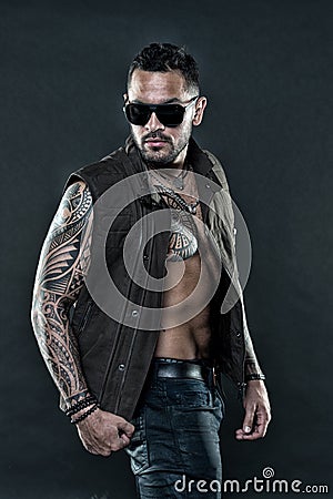 Tattooed man with six pack and ab. Bearded man with tattoo on chest and arms. Tattoo model with beard on unshaven face Stock Photo