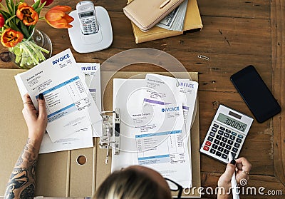 Tattooed Woman doing accounting work Stock Photo