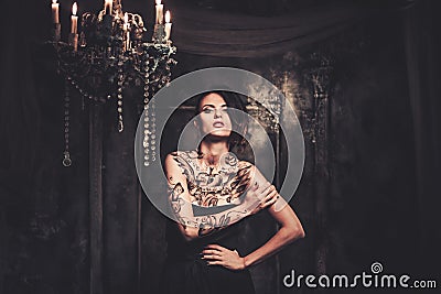 Tattooed woman in spooky interior Stock Photo