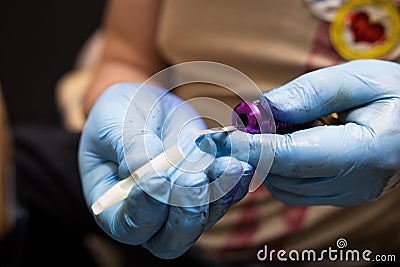 Tattooer showing process of making a tattoo, hands holding a tatoo machine Stock Photo