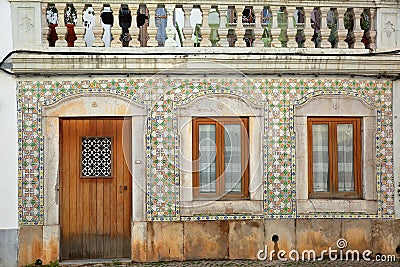 Close-up on a typical house facade with patterned tiles azulejos inside the old town of Tavira Editorial Stock Photo