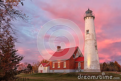 Tawas Point Lighthouse at Sunset in Tawas Michigan Stock Photo