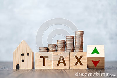 TAX block with house model and coin money stack. real estate, Home loan, taxation, payment and financial concept Stock Photo