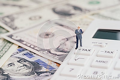 Tax calculation or tax refund for individual or company concept, miniature businessman leader standing and thinking with tax plus Stock Photo