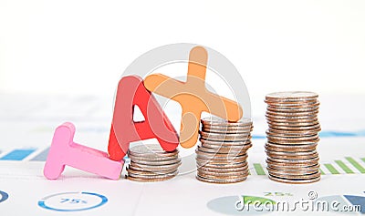 TAX composed of a row of growing dollar coins and English letter models on a financial chart Stock Photo