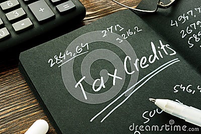 Tax credits inscription and page with financial calculations. Stock Photo