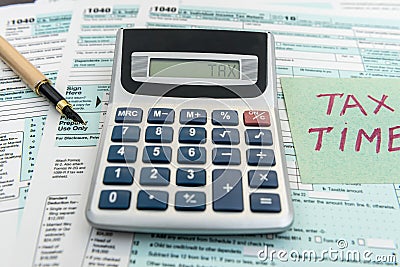 Tax financial forms with pen and calculator and sticker with text Tax Time Stock Photo
