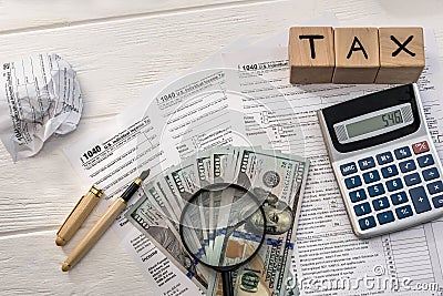 1040 tax form with dollar, calculator and wooden cubes Editorial Stock Photo