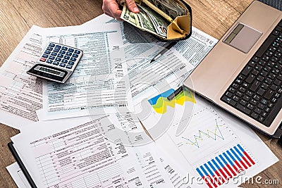 Tax form, money business chart laptop and calculator Editorial Stock Photo