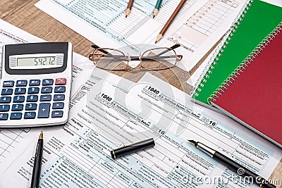 Tax form with notepad, pen, pencil and calculator Editorial Stock Photo