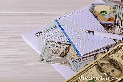 The tax 1040 forms with money and the pen. Editorial Stock Photo