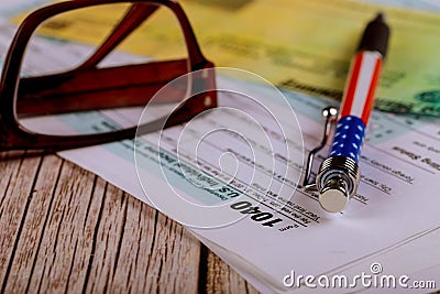 Tax 1040 forms with pen, glasses with accountant& x27;s office individual income tax return Editorial Stock Photo